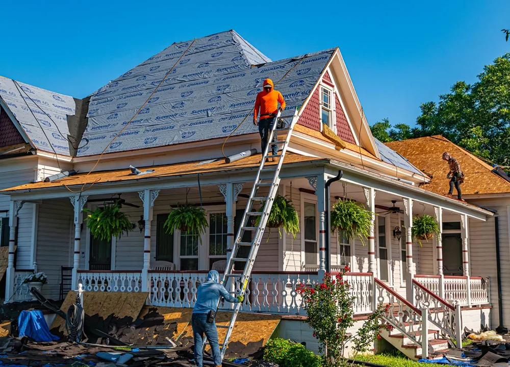 Roofing contractors working on a residential roof